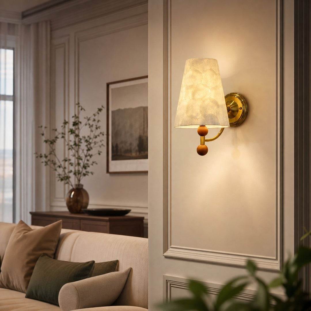 Capiz shell wall sconce glowing in an elegant paneled sitting room
