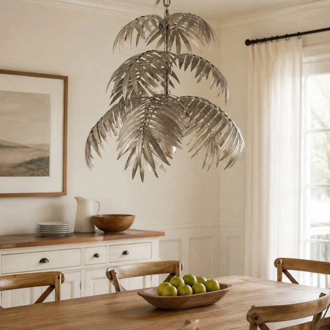 Tiered silver palm leaf chandelier in a dining room