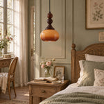 Charger l'image dans la visionneuse de galerie, Brown glass pendant beside a bedroom bed