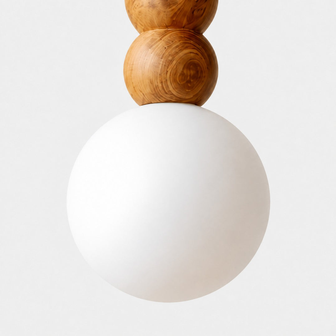Close view of the frosted glass globe and lower wood bead connection