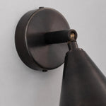 Load image into Gallery viewer, Round wall plate and adjustable arm detail on matte black wall light