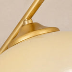 Bild in Gallery-Viewer laden, Close-up of the gold lamp arm and white glass shade