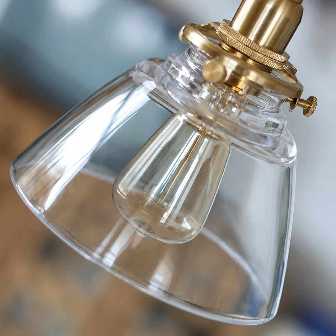 Close view of brass socket and clear glass shade