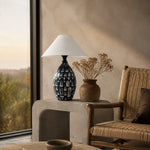 Load image into Gallery viewer, Black ceramic table lamp styled in a warm lounge corner