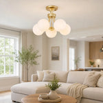 Load image into Gallery viewer, Gold globe ceiling light in a bright living room