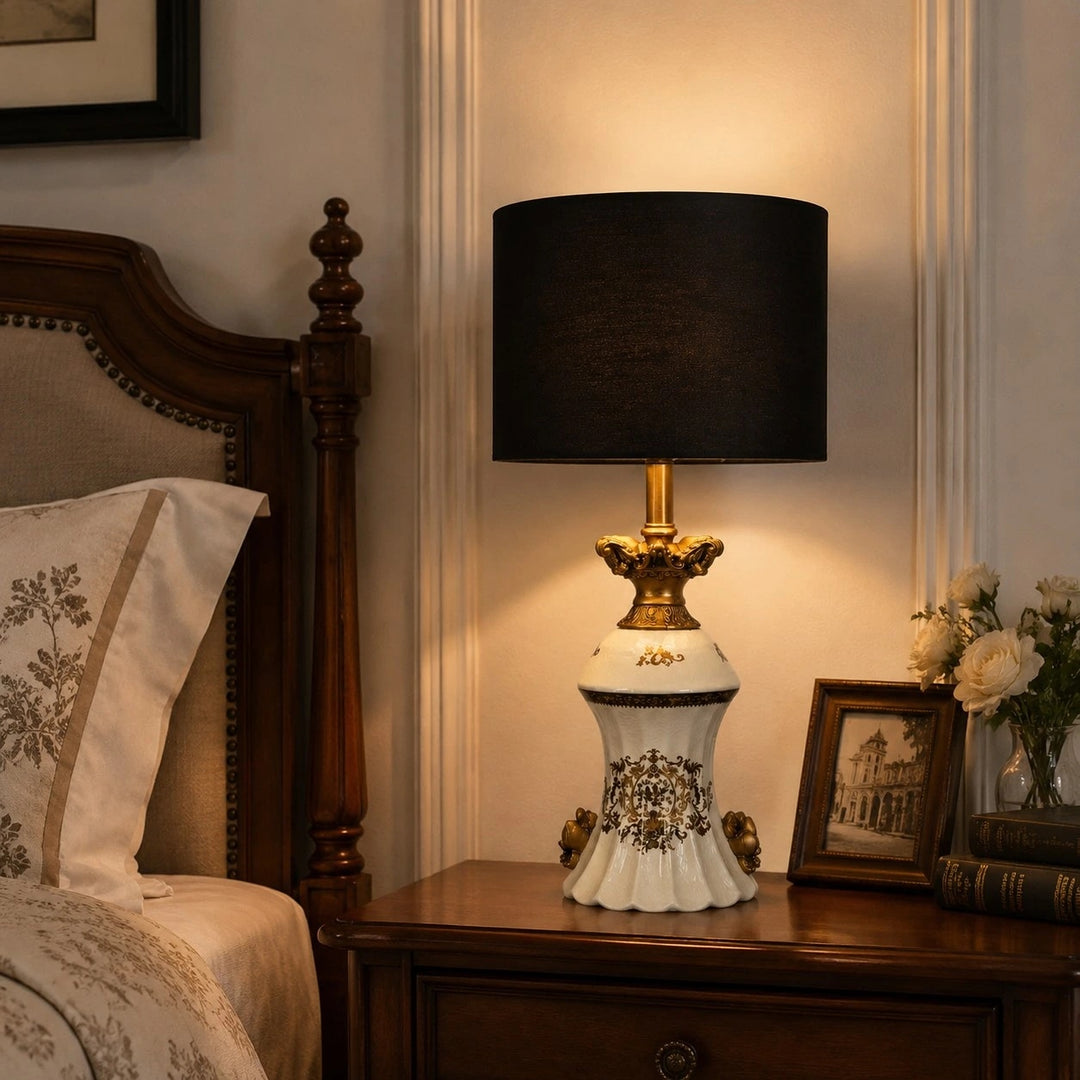 Gold motif ceramic table lamp on a bedside table