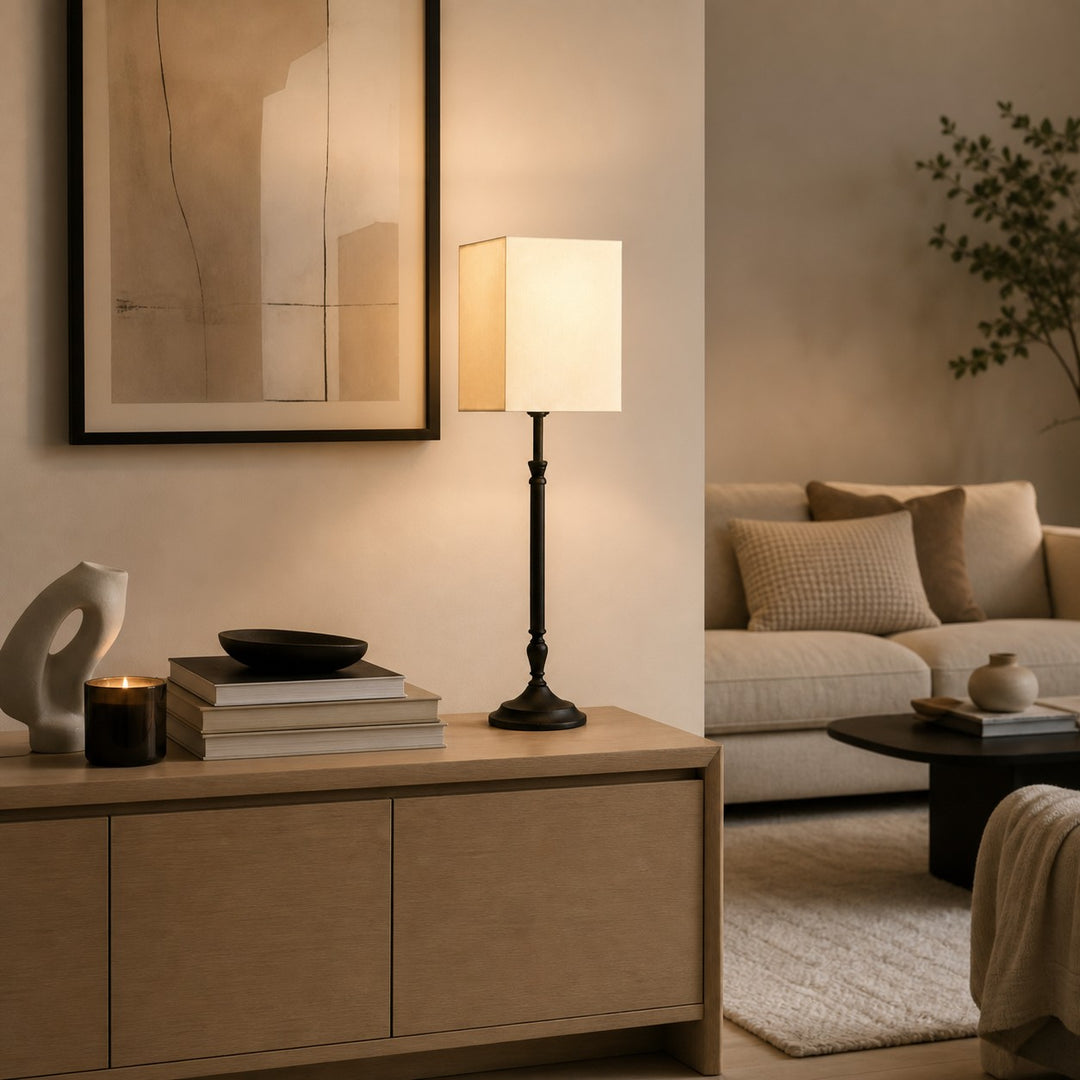 Square fabric shade table lamp on a console in a living room