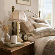 Fabric shade table lamp styled on a bedside table