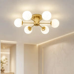 Load image into Gallery viewer, Six-head gold globe ceiling light in a bright modern interior