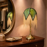 Bild in Gallery-Viewer laden, Vintage green tassel table lamp on a dressing table