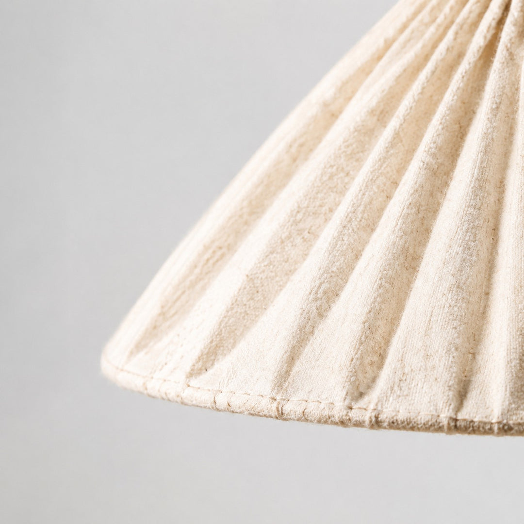 Close-up of natural linen weave, stitched pleats and finished shade edge