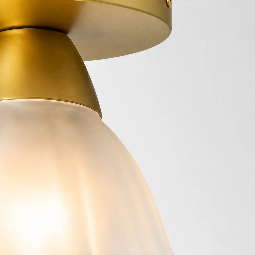 Brushed gold lamp holder and frosted glass connection detail