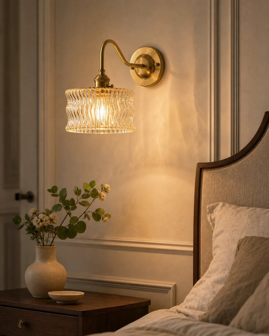 Vintage ripple glass wall sconce installed above a bedside table
