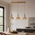 Cargar imagen en el visor de la Galería, Amber brass flower pendant above a dining table