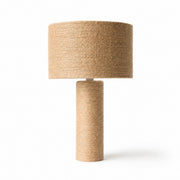 Woven jute cylinder table lamp on a white background