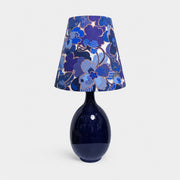 Blue floral fabric ceramic table lamp on plain background