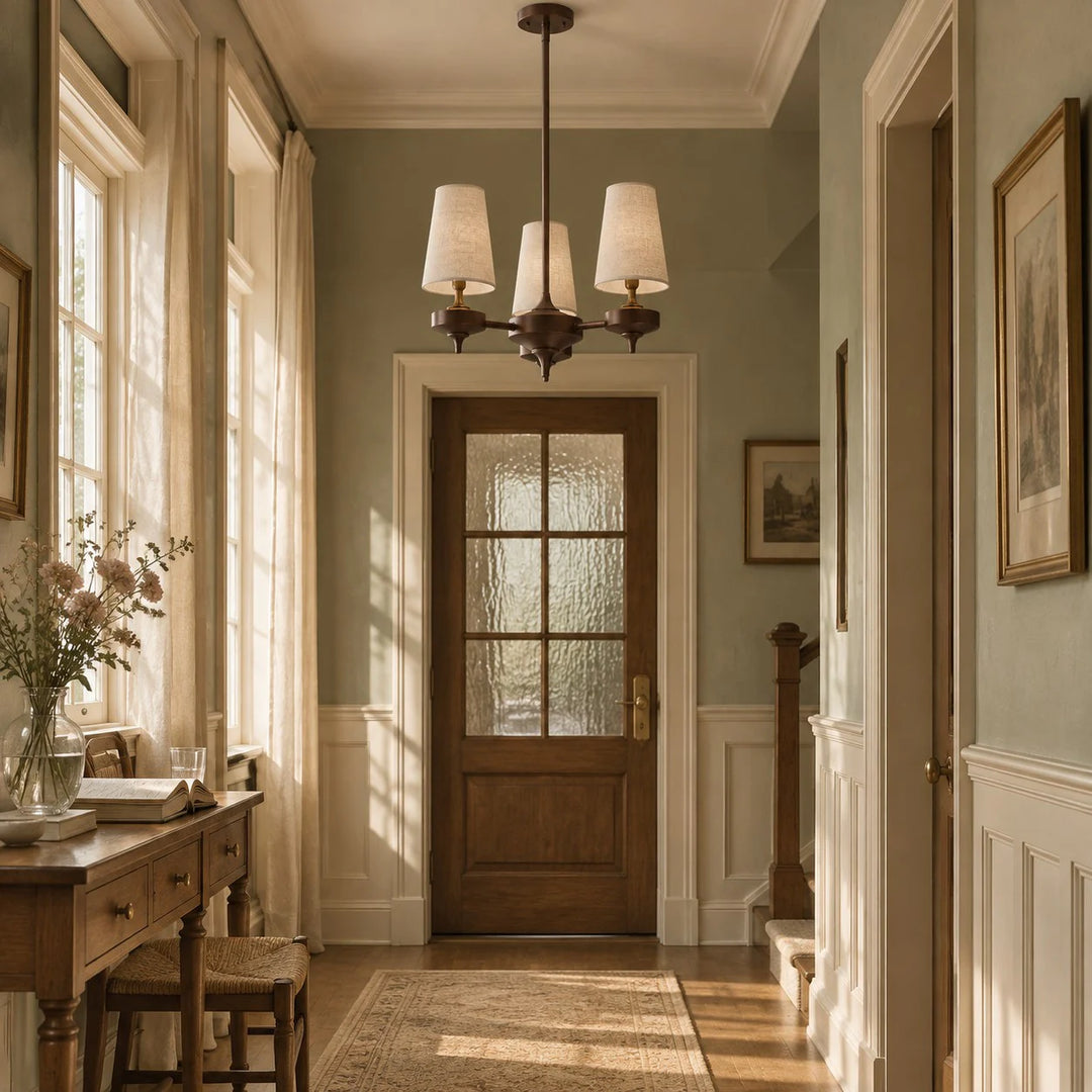 3-light Hour Rho chandelier in white velvet styled in a warm interior