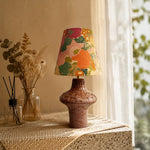 Cargar imagen en el visor de la Galería, Orange floral ceramic table lamp on a textured console table