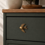 Cargar imagen en el visor de la Galería, Antique brass swallow cabinet knob on a dark green drawer