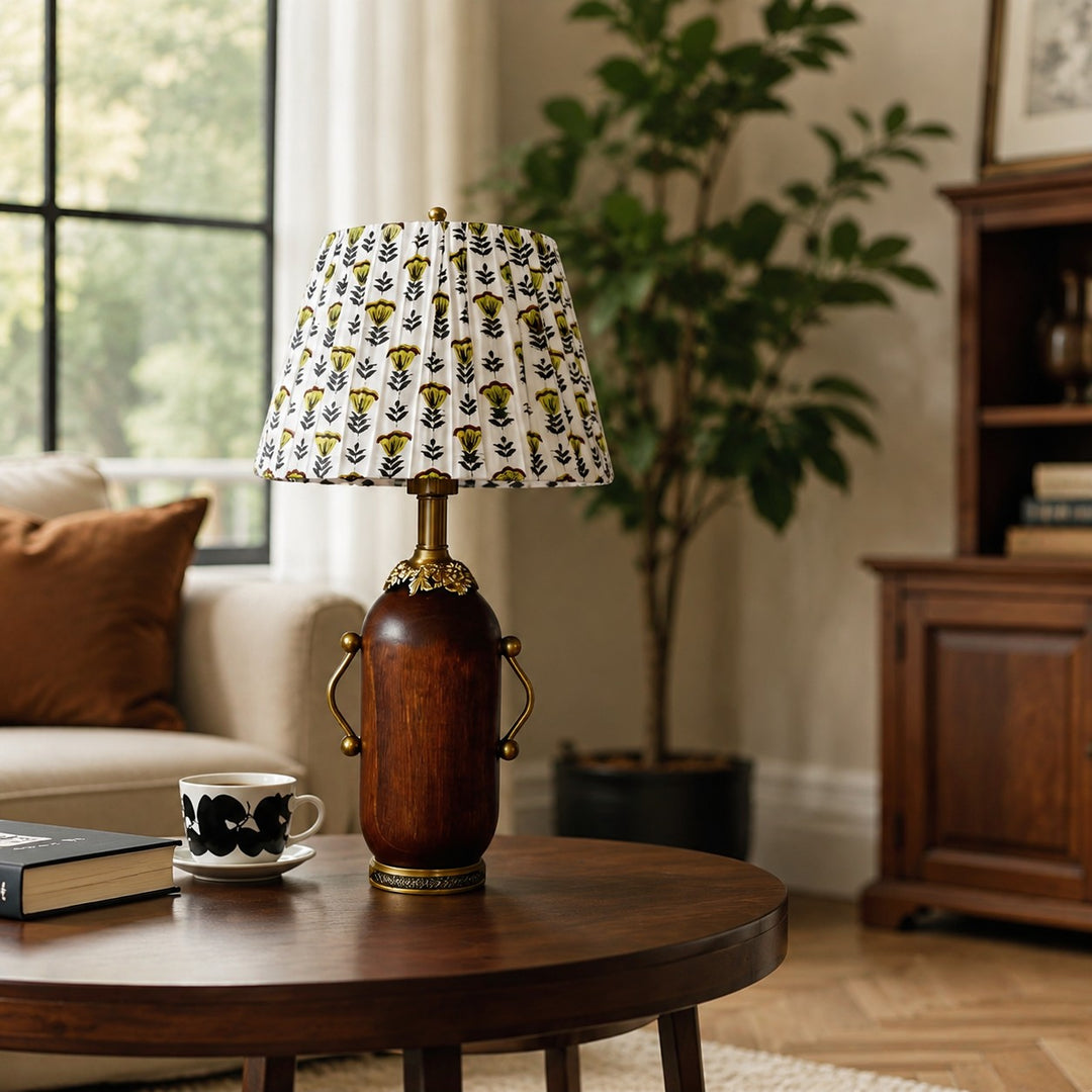 Deep brown floral table lamp styled beside a green armchair