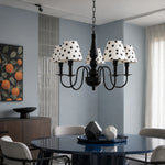Load image into Gallery viewer, Black polka dot chandelier above a modern dining table