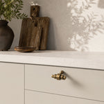 Load image into Gallery viewer, Antique brass cabinet handle in a warm modern interior