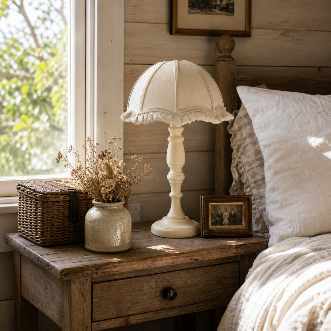 Fabric shade wood table lamp styled near a bedroom window