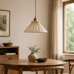 Charger l'image dans la visionneuse de galerie, Pleated linen pendant light over a round wood dining table beside a bright window