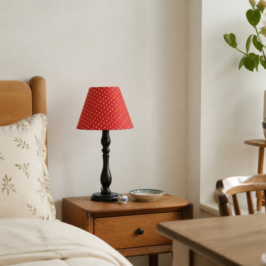 Red shade table lamp in a cozy bedroom setting