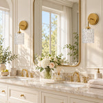 Cargar imagen en el visor de la Galería, Clear hammered-glass sconce on a marble vanity, lights off