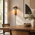 Load image into Gallery viewer, Walnut and black travertine wall sconce in a daylight bedroom