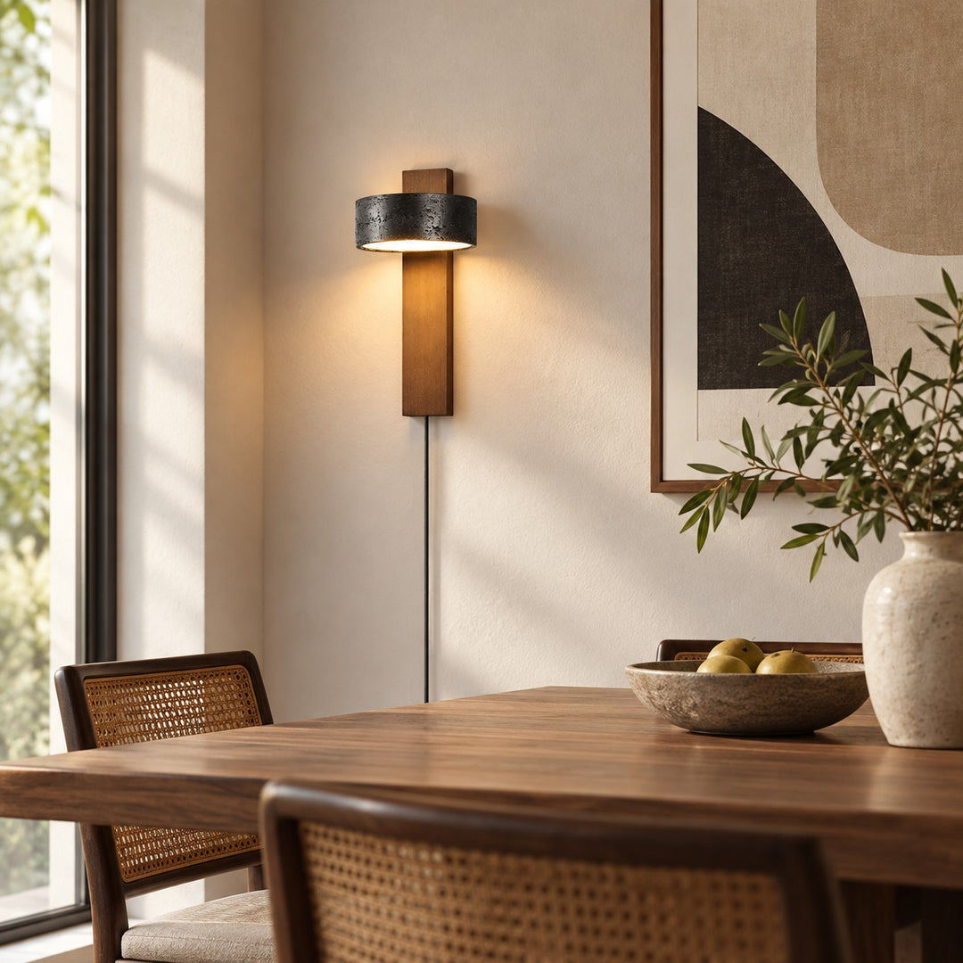 Walnut and black travertine wall sconce in a daylight bedroom