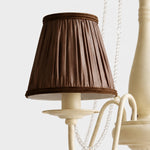 Bild in Gallery-Viewer laden, Close-up of pleated brown fabric chandelier shade with wrapped trim