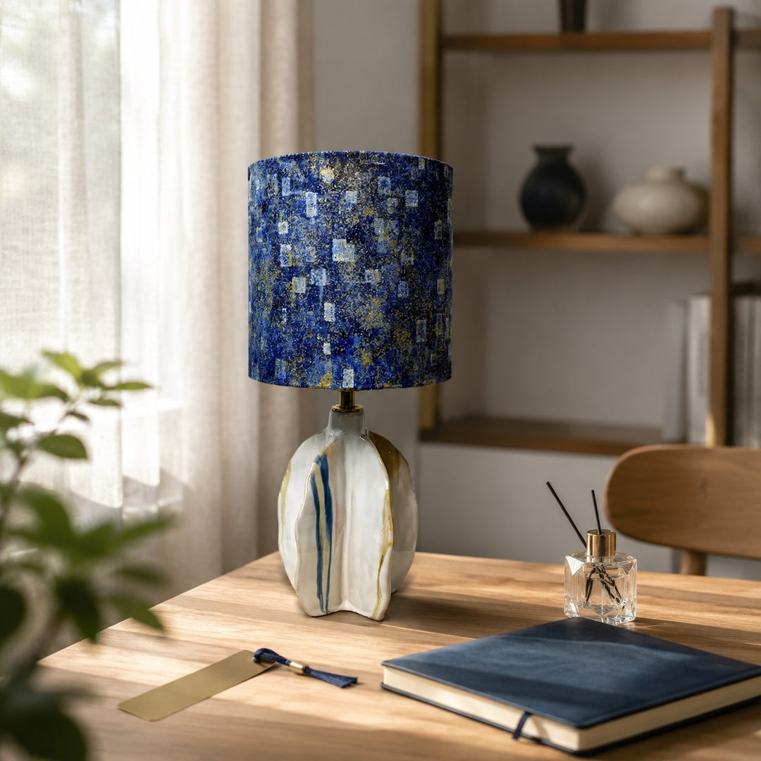 Blue abstract ceramic table lamp on a styled desk