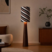 Striped fabric floor lamp styled beside a sideboard in a warm living room